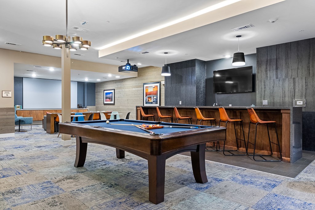 a game room with a pool table and a tv