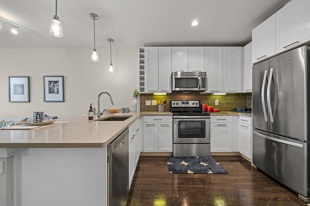 a kitchen with stainless steel appliances and white cabinets