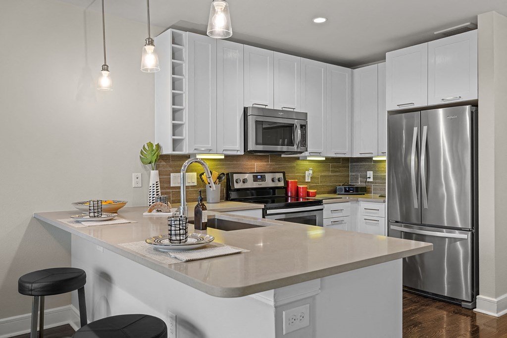 a kitchen with stainless steel appliances and a counter top