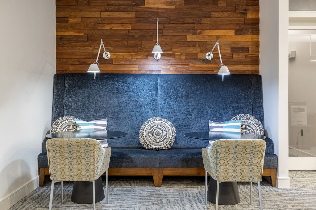 a living room with a couch and chairs and a table