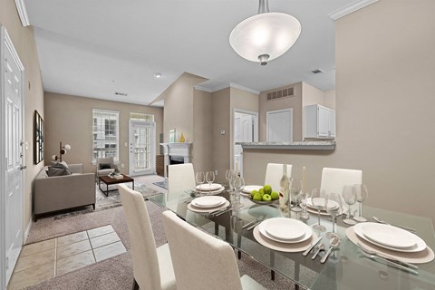 A modern dining room with a glass table and white chairs.