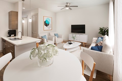A modern living room with a white table and chairs.