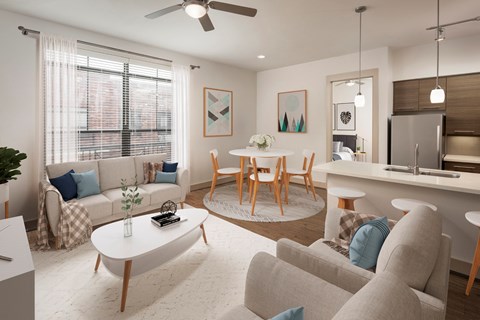 A living room with a white couch, a coffee table, and a ceiling fan.