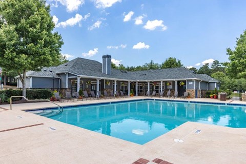 a swimming pool with a house in the background