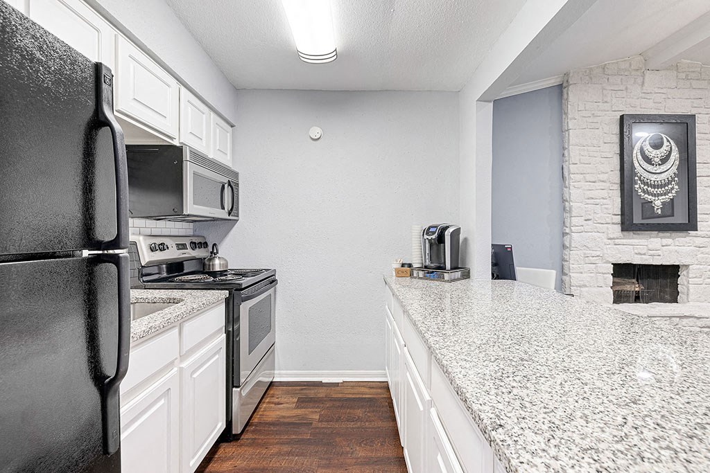 a kitchen with a counter top and a refrigerator