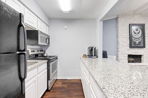 a kitchen with a counter top and a refrigerator