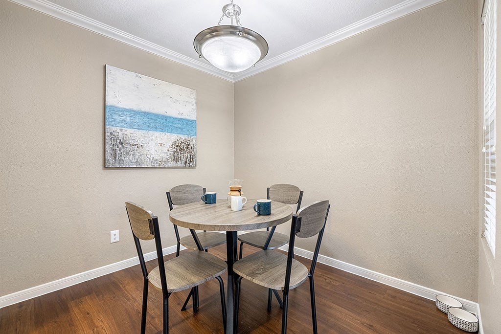 a dining room with a table and four chairs