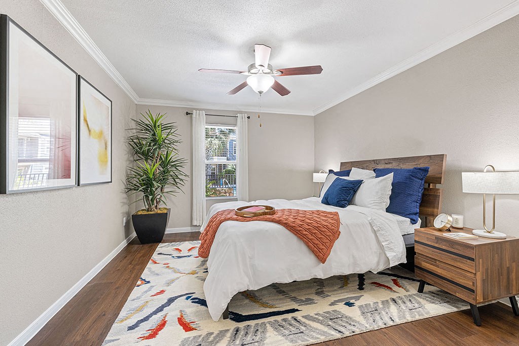 a bedroom with a bed and a ceiling fan