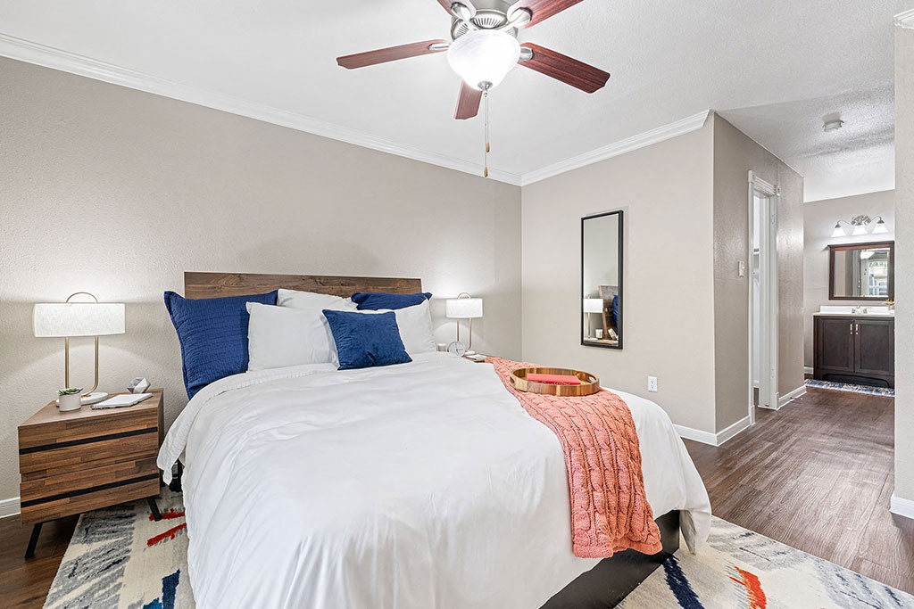 a bedroom with a bed and a ceiling fan