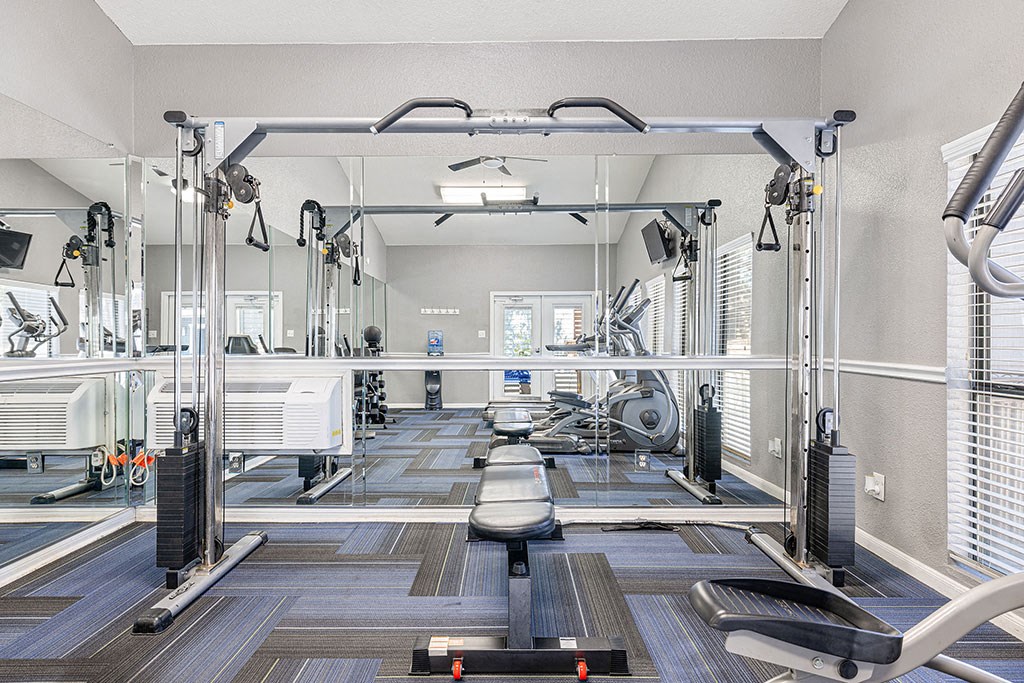 a gym with weights machines and other workout equipment