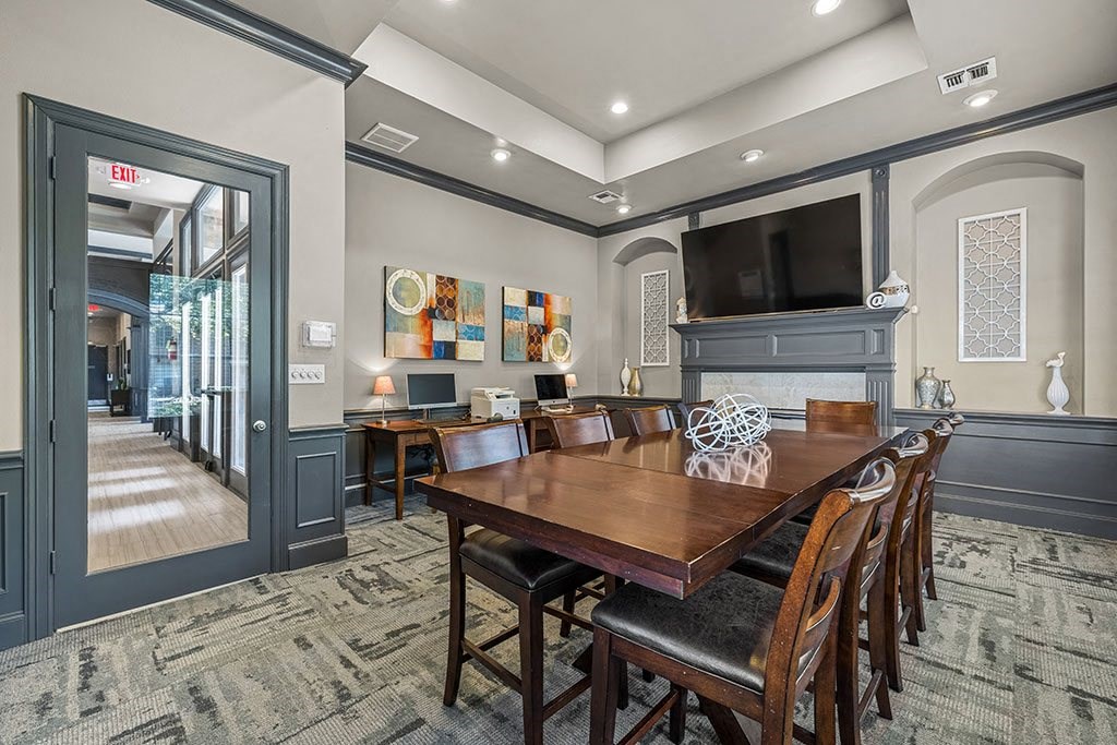 a dining room with a table and a tv