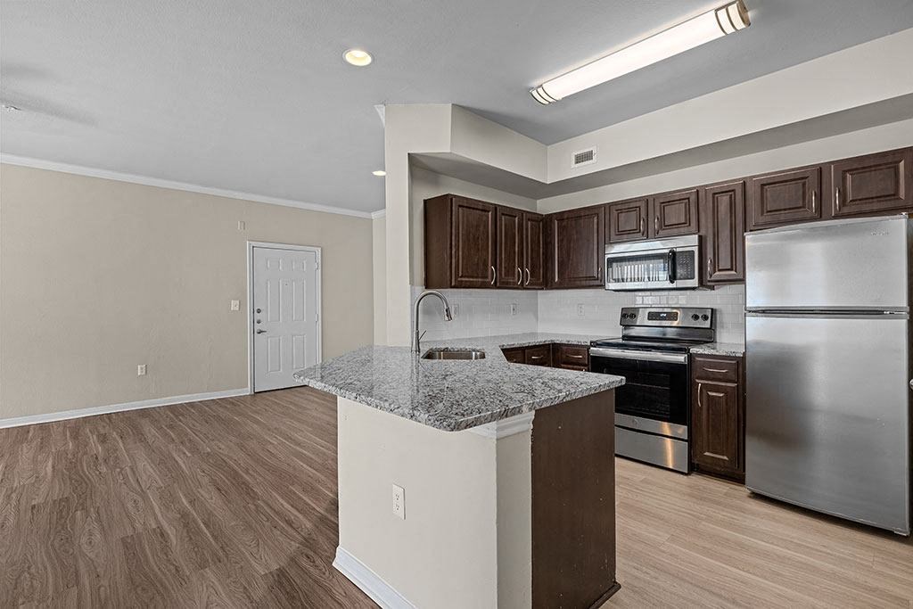 a kitchen with stainless steel appliances and a granite counter top