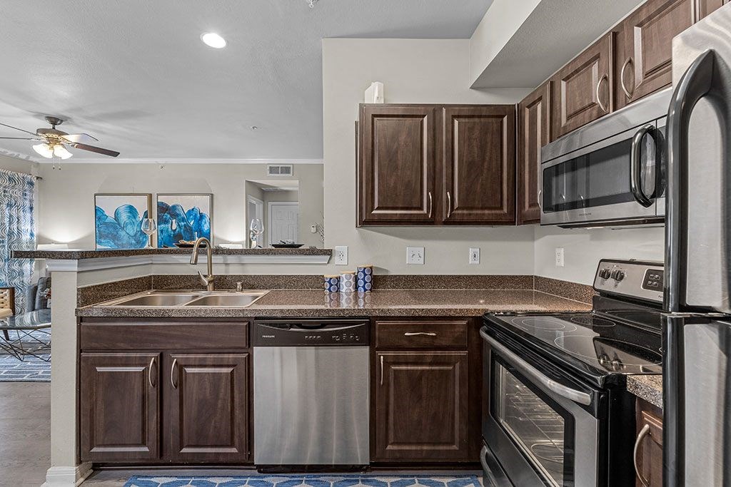 a kitchen with stainless steel appliances and wooden cabinets