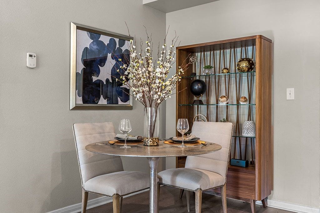 a dining room with a table and chairs
