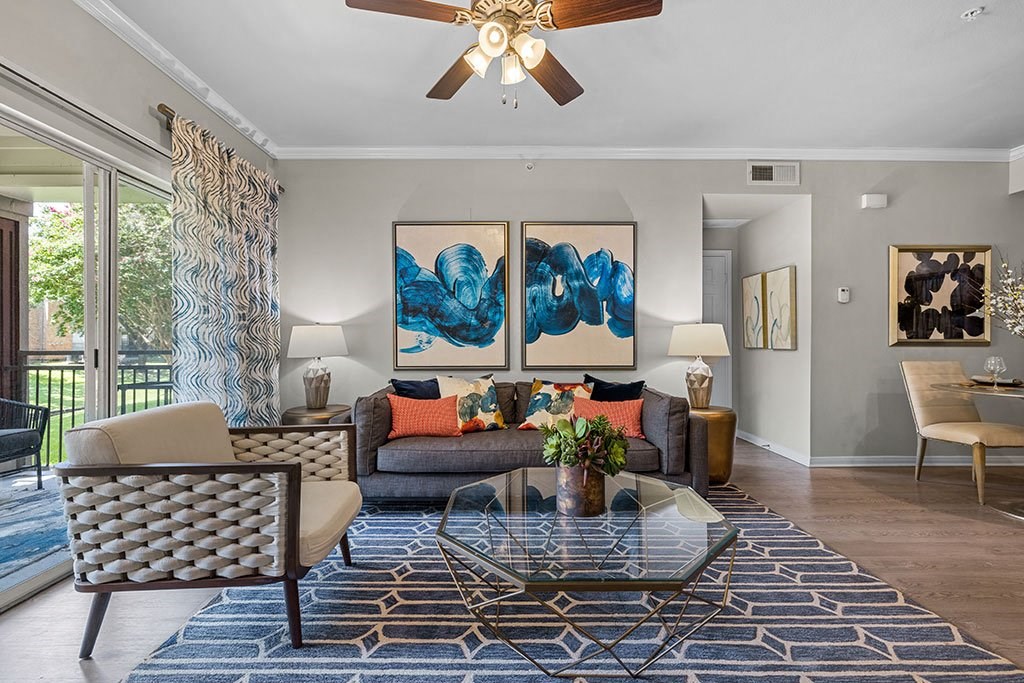 a living room with a couch and a ceiling fan