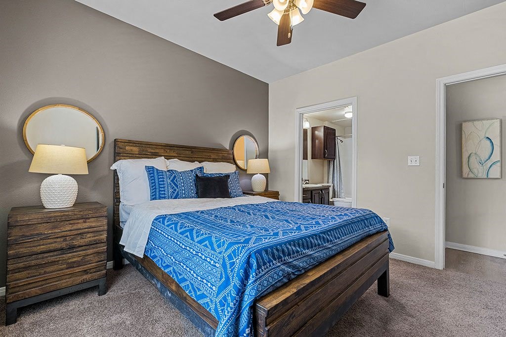 a bedroom with a bed and a ceiling fan