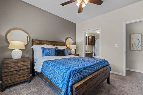 a bedroom with a bed and a ceiling fan