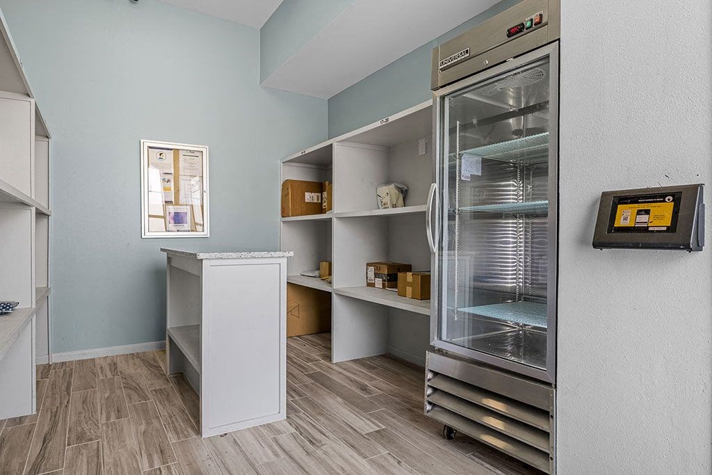 a room with a refrigerator and a counter