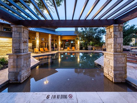 a swimming pool is shown in the backyard of a house