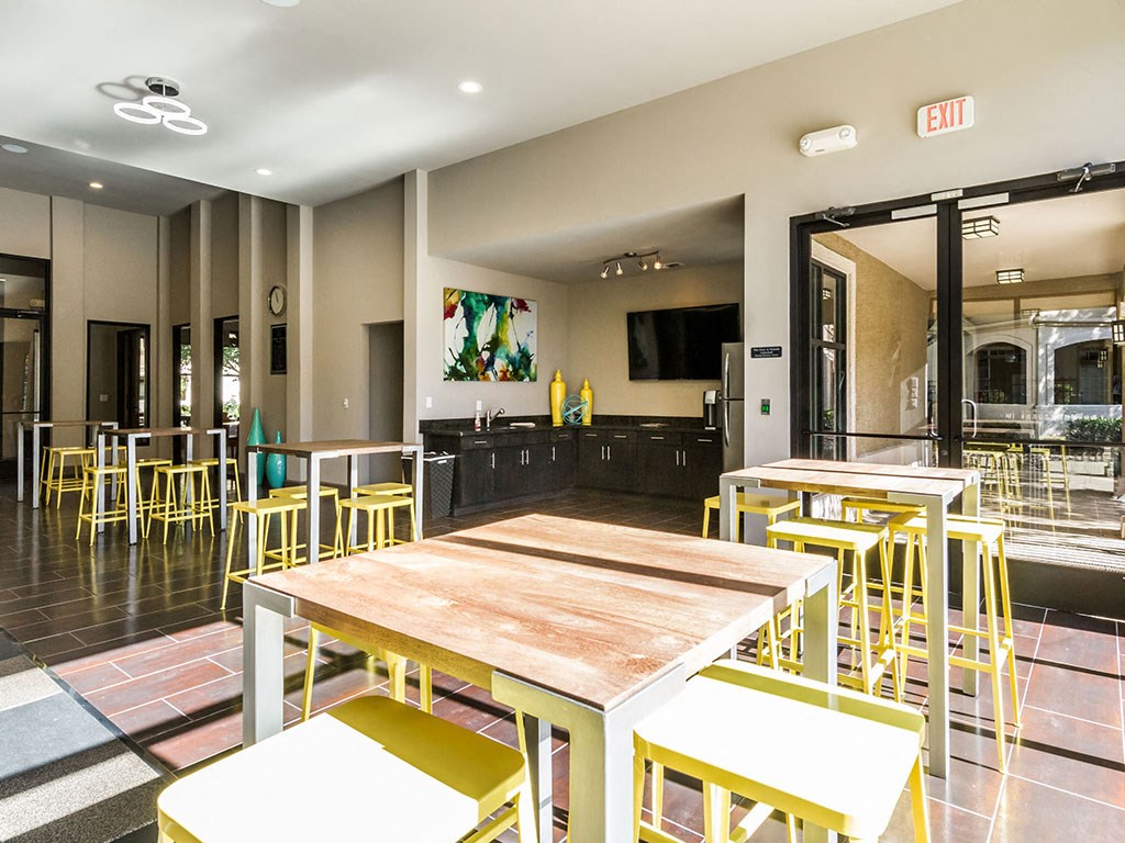 a dining room with tables and chairs and a bar