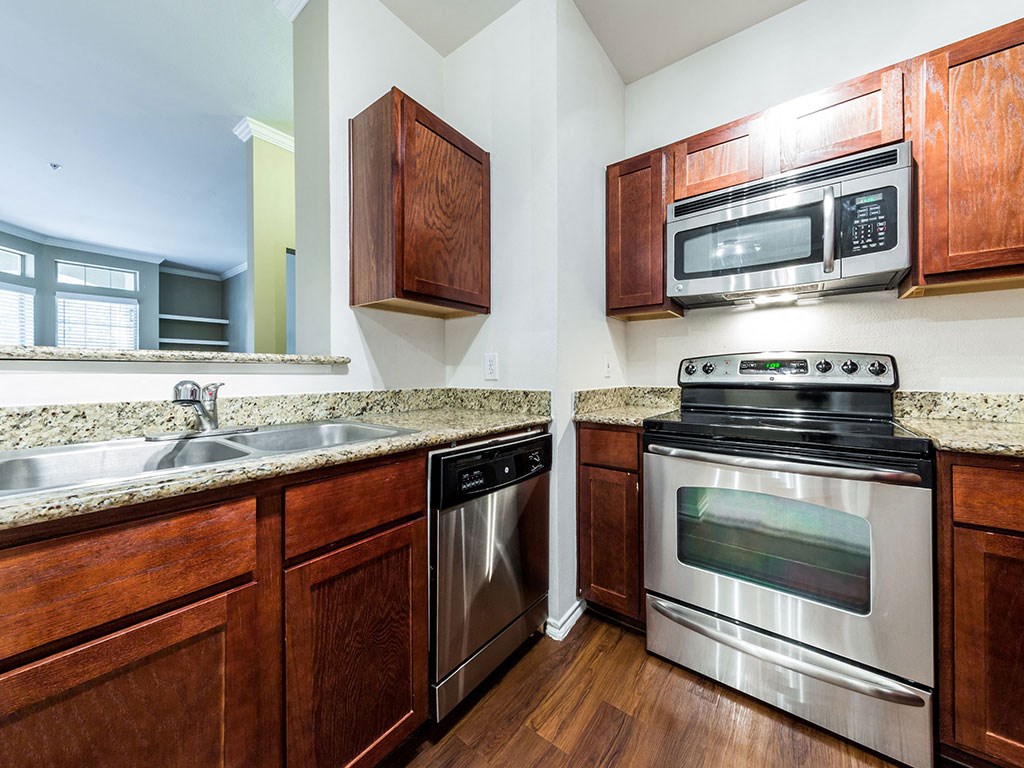 a kitchen with stainless steel appliances and wooden cabinets