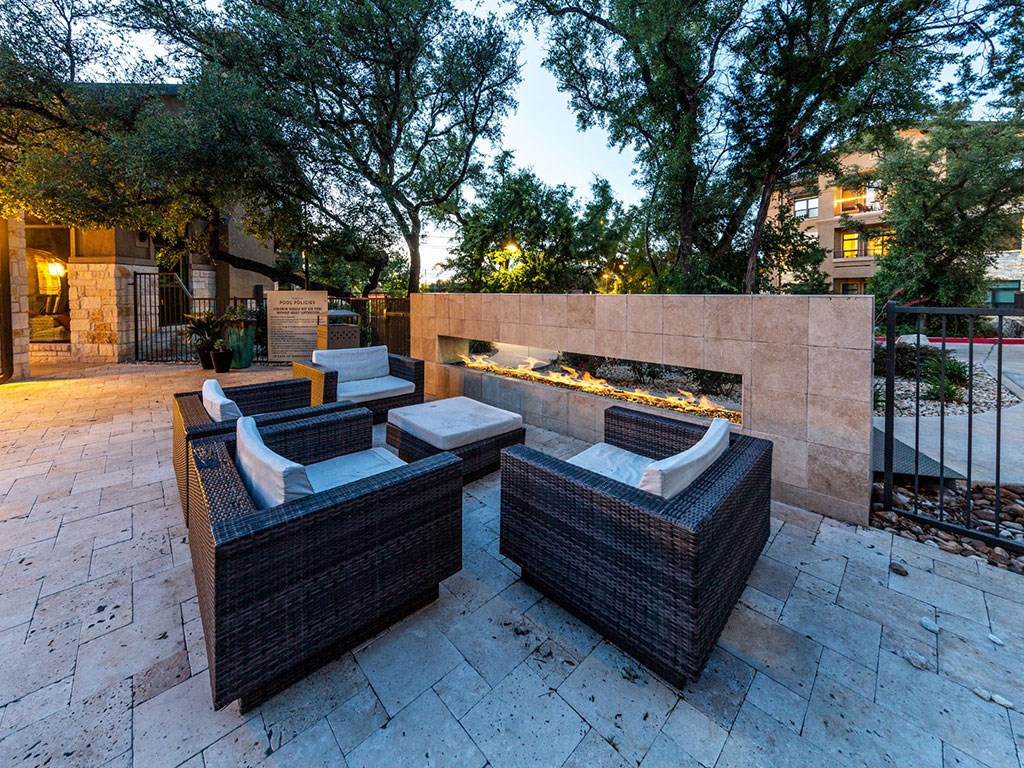 a patio with furniture and a fire pit