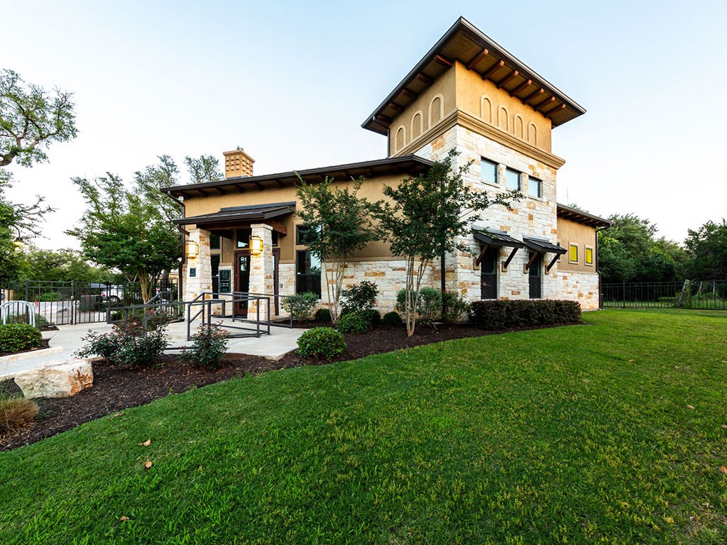 the front of a house with a lawn and a porch