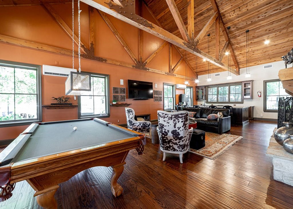 a game room with a pool table and a tv