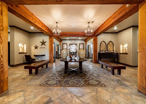 a large lobby with a table and benches