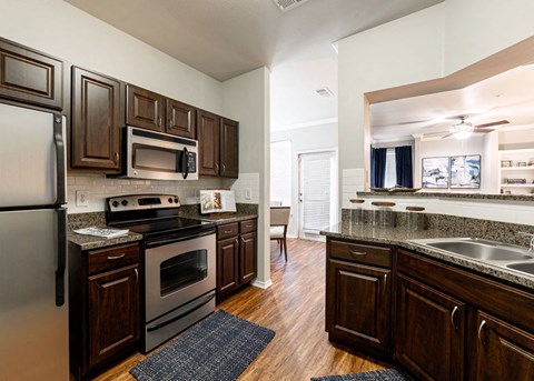 a kitchen with wooden cabinets and stainless steel appliances