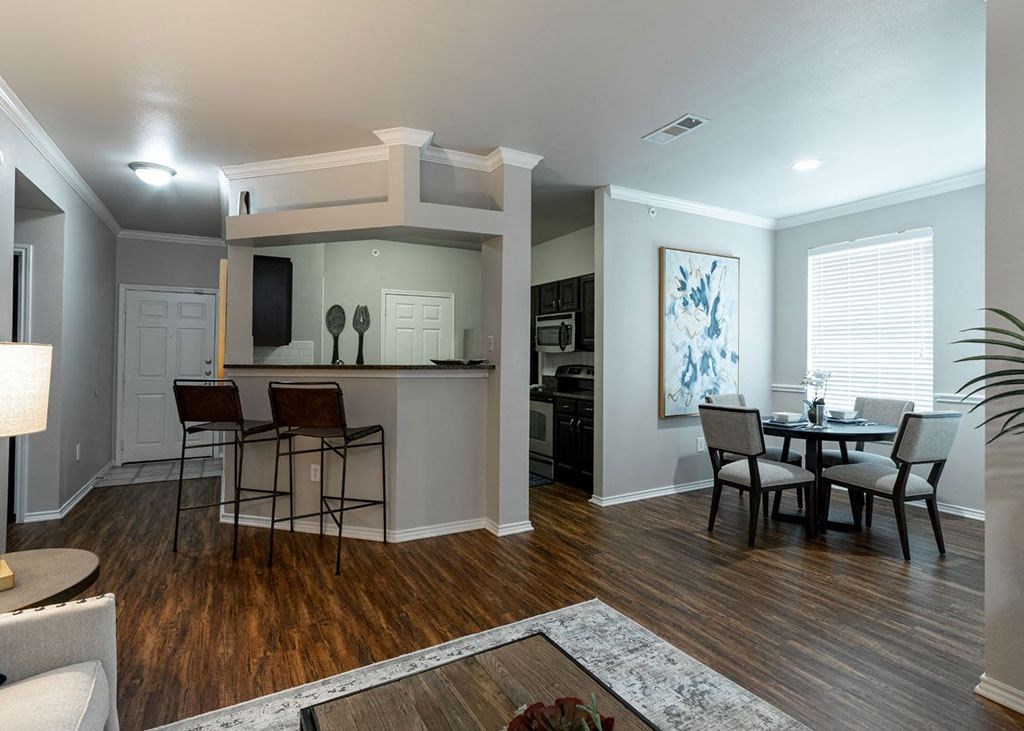 an open living room and kitchen with a table and chairs