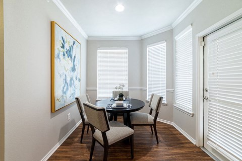 a dining room with a table and chairs