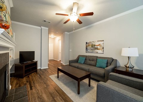 a living room with a couch and a ceiling fan
