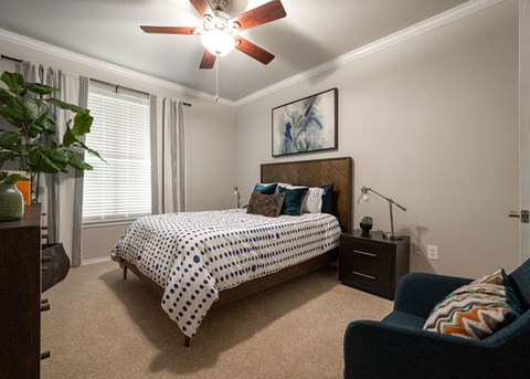 a bedroom with a bed and a ceiling fan