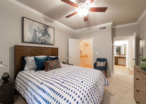 a bedroom with a bed and a ceiling fan