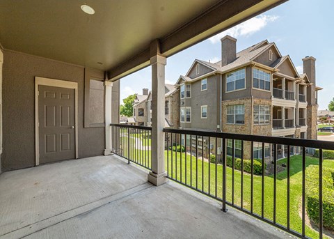a balcony with a view of an apartment building