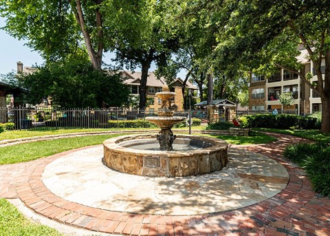 a fountain in the middle of a park