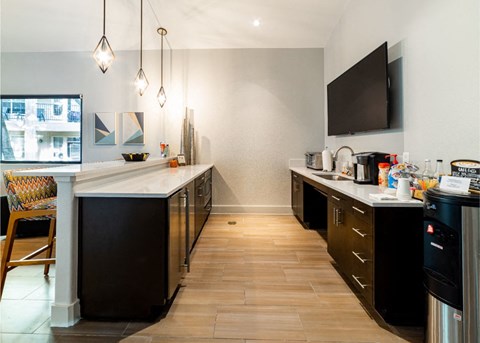 A modern kitchen with dark wood cabinets and a white countertop.