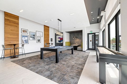 a game room with a pool table     and a bar