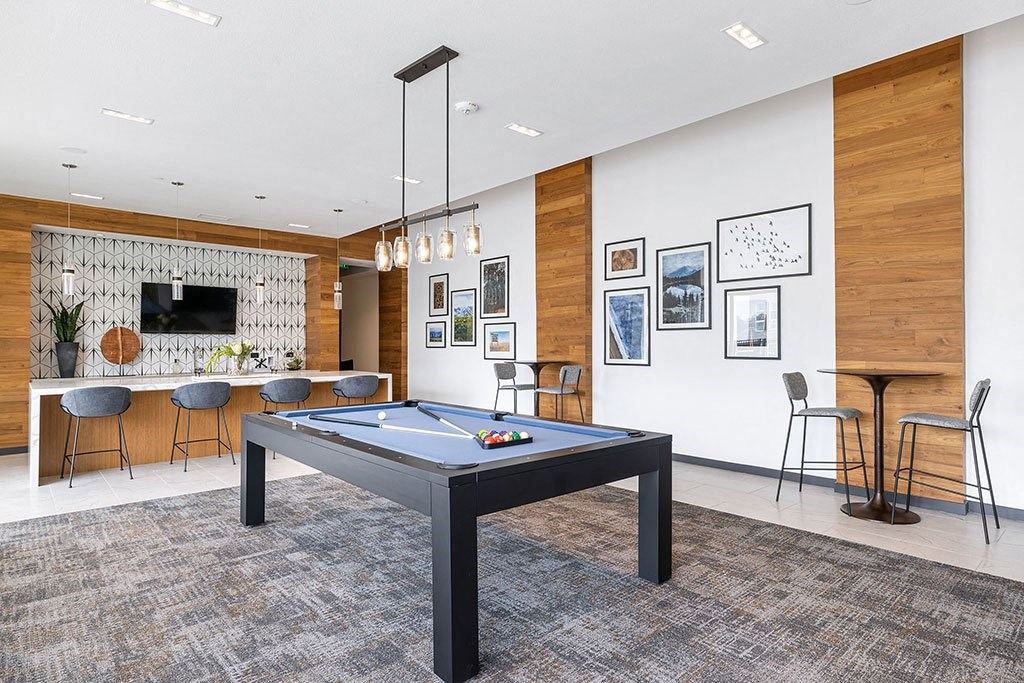 a game room with a pool table and a bar