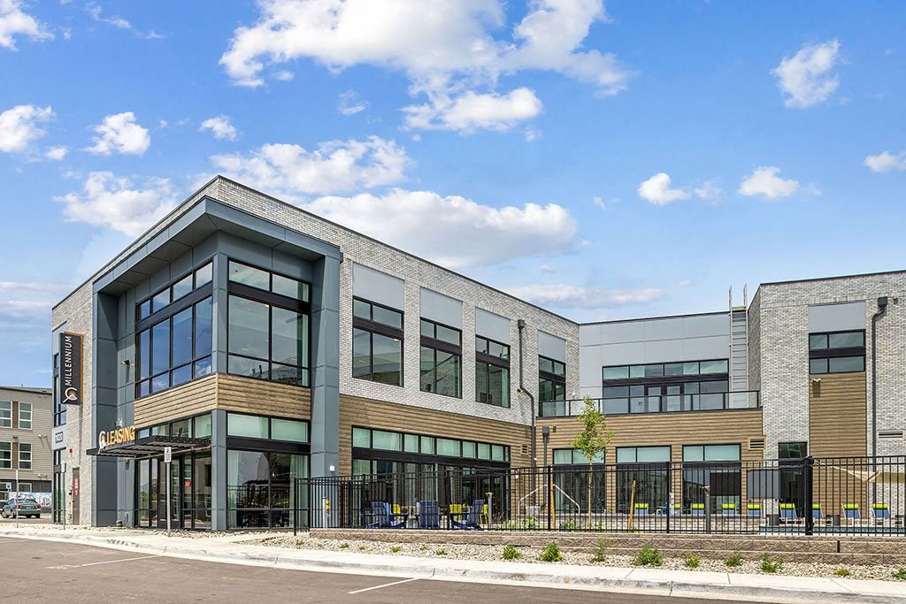 the front of a building with a fence