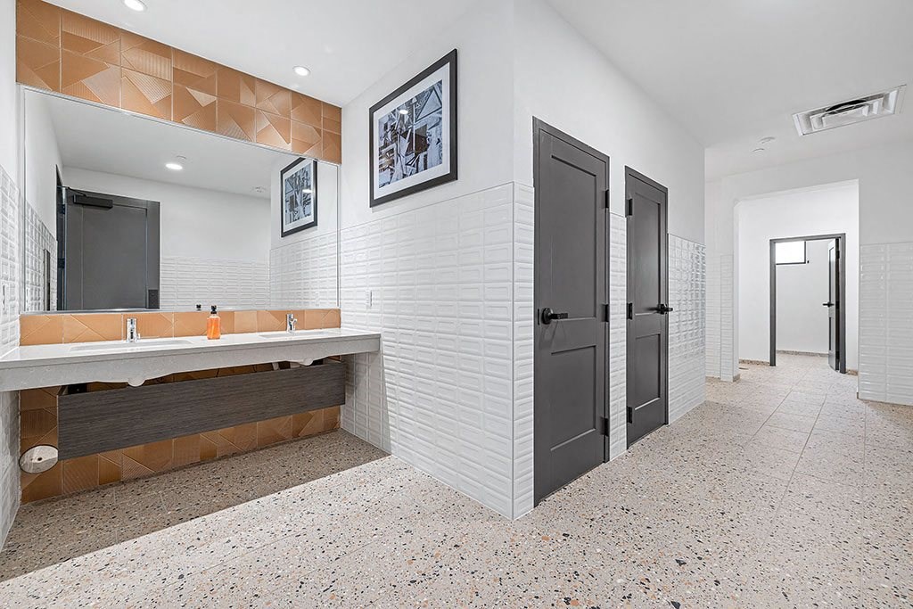 a bathroom with a large mirror and a door