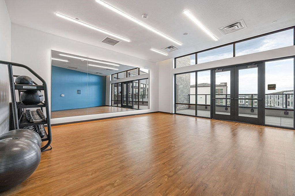 an empty room with a wood floor and a large window