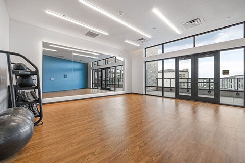 an empty room with a wood floor and a large window