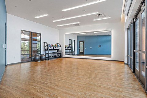 a large room with a hard wood floor and a mirror
