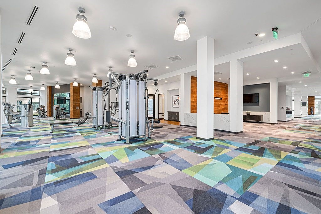 the gym in the building is equipped with cardio machines and weights