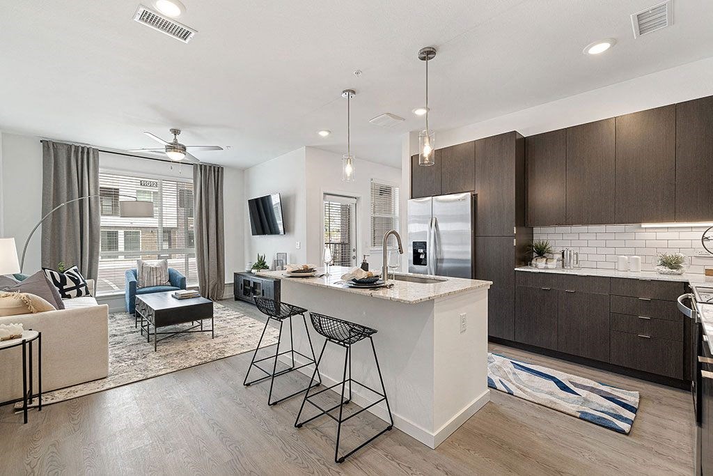 a kitchen and living room with a white counter top
