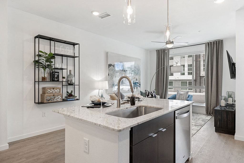 an open kitchen and living room with a sink
