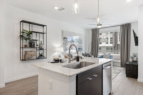 an open kitchen and living room with a sink