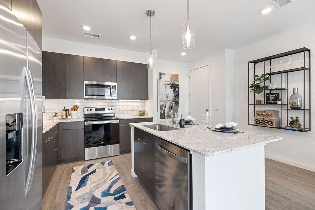 a kitchen with an island and stainless steel appliances